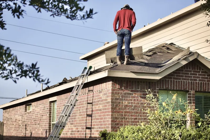 Professional roofer working on a residential roof in Quail Trail